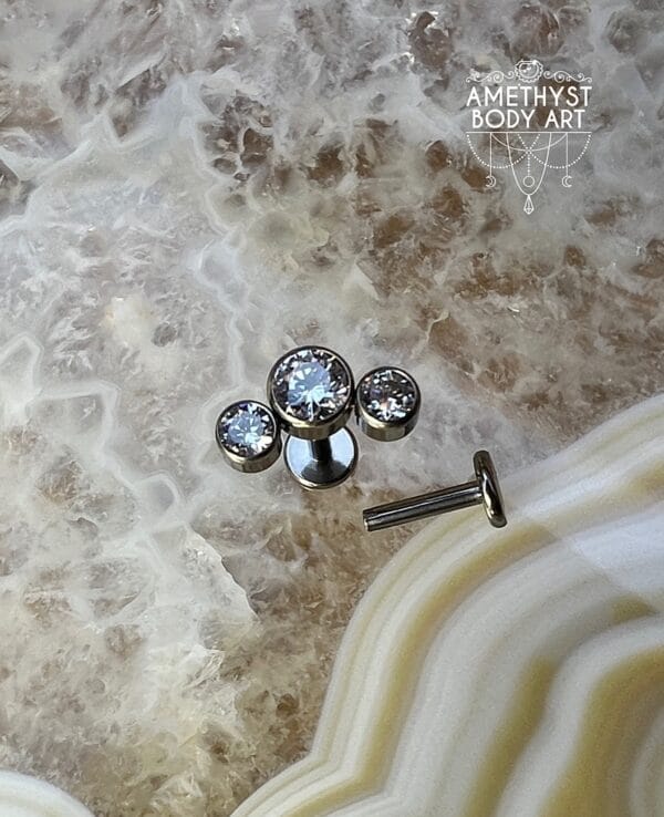 Cluster with 3 Bezel set Clear CZ and Titanium Labret.