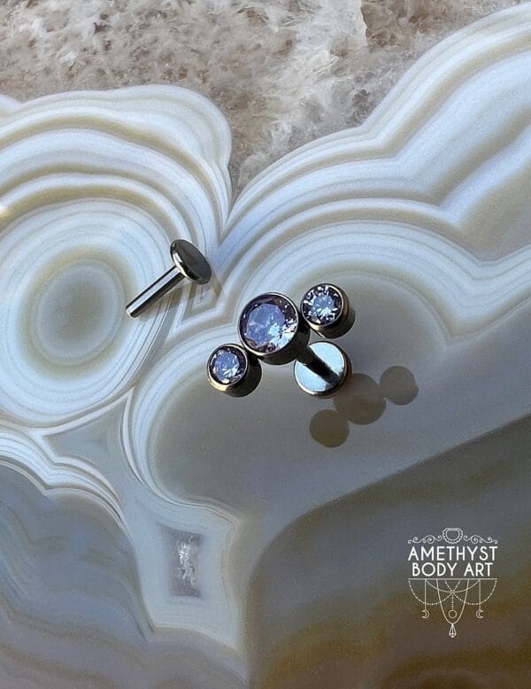 Cluster with 3 Bezel set Purple CZ and Titanium Labret.